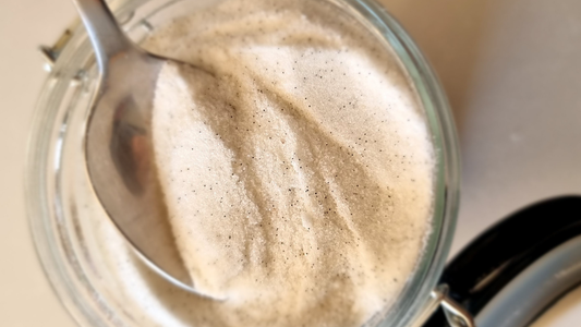 Homemade vanilla sugar in a glass jar, mixed with Madagascar vanilla bean seeds (also called vanilla caviar) and sugar