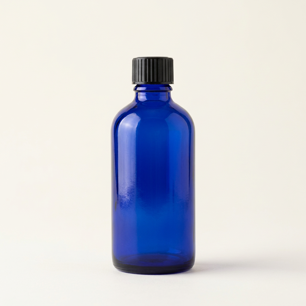 Blue glass 100 mL pharmacy bottle and black cap, alternate view